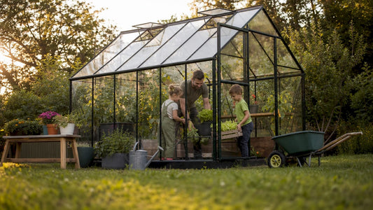 Family tending plants in home lean-to greenhouse