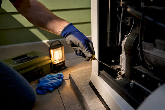 Homeowner checking generator oil level